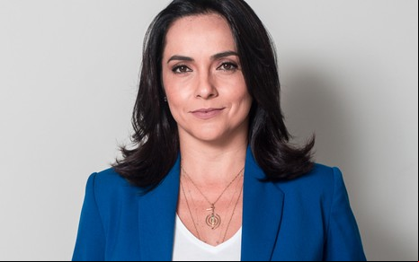 A jornalista Izabella Camargo de terno azul e expressão séria em foto de divulgação de seu livro