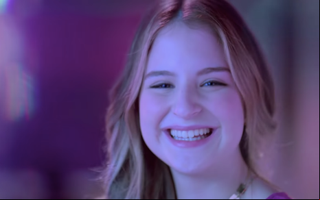 A atriz Sophia Valverde sorri como a personagem Poliana na novela Poliana Moça, do SBT