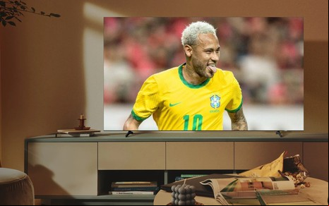 TV em sala decorada exibe jogo da seleção na Copa 2022