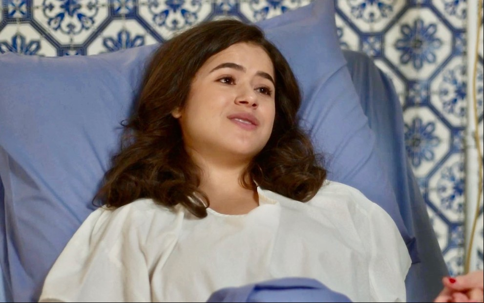 A atriz Maisa em cama de hospital, com expressão complacente em cena de Garota do Momento