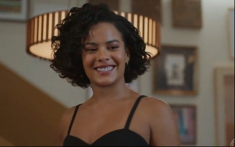 Bella Campos sorri em cena como Maria de Fátima na novela Vale Tudo