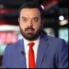 Pedro Duran usa terno cinza e gravata vermelha; ao fundo está a Redação da CNN Brasil