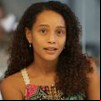 Taís Araujo sorri discretamente em cena como Raquel na novela Vale Tudo